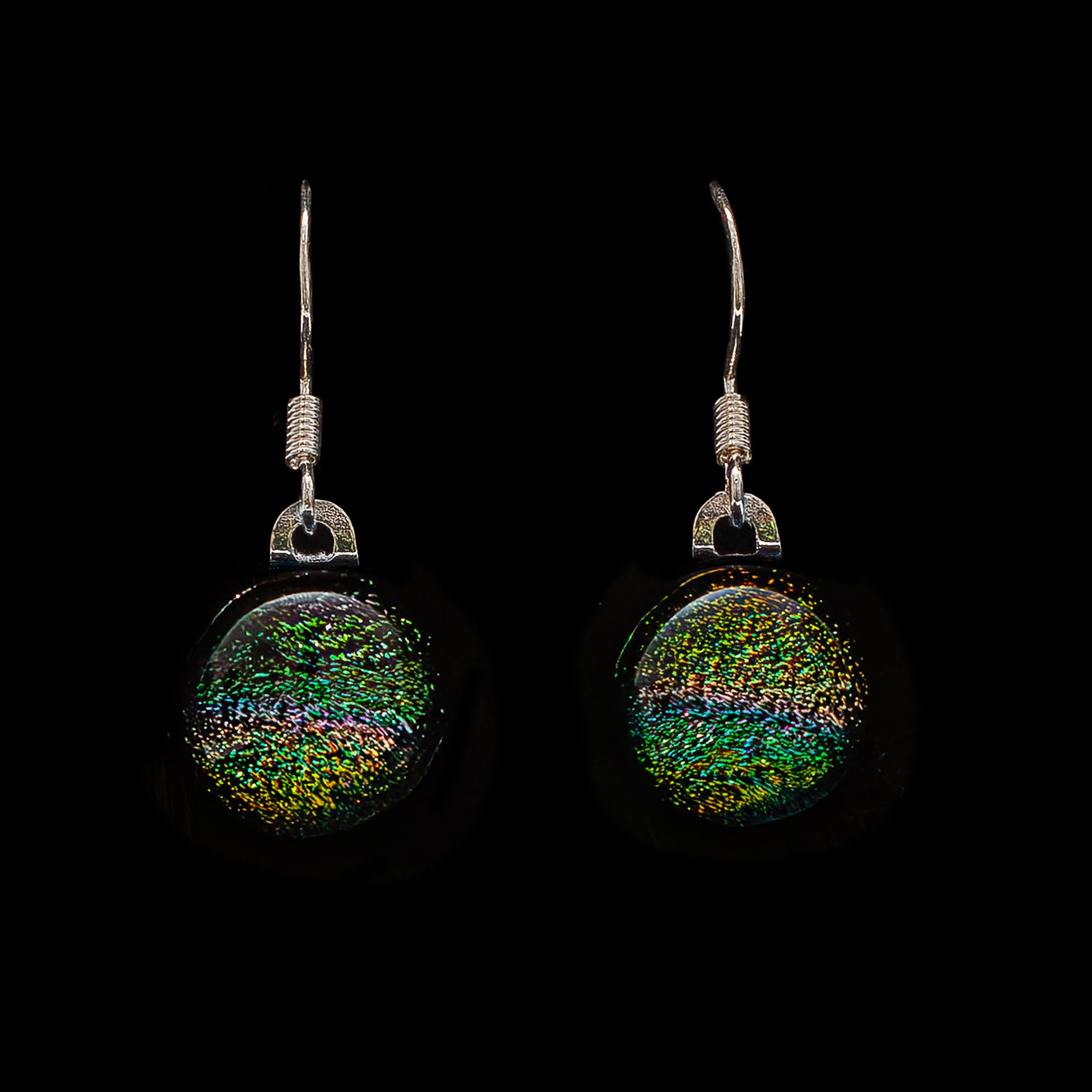 Round green and orange striped dichroic glass drop earrings with colour-shift shimmer, handmade in London by Invoke London with sterling silver hooks.