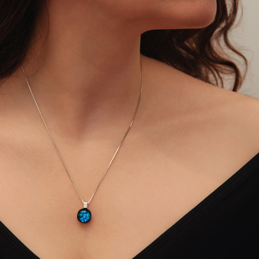 Necklace with a blue pendant worn by a person