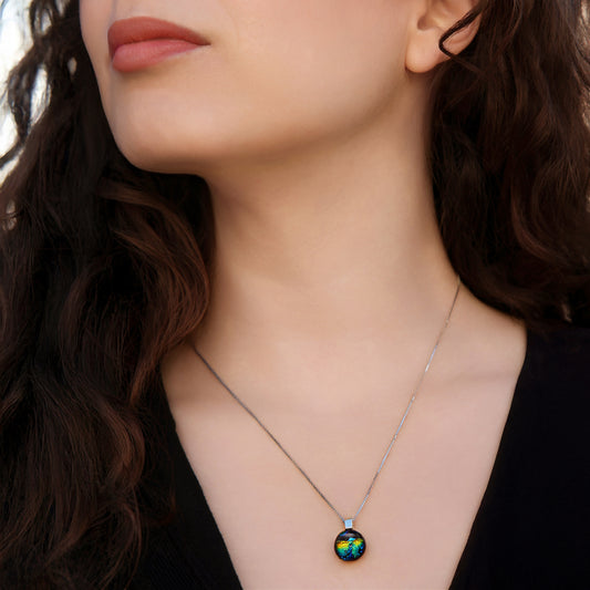 Close up of model wearing green and gold ripple Orb pendant necklace with sterling silver chain.