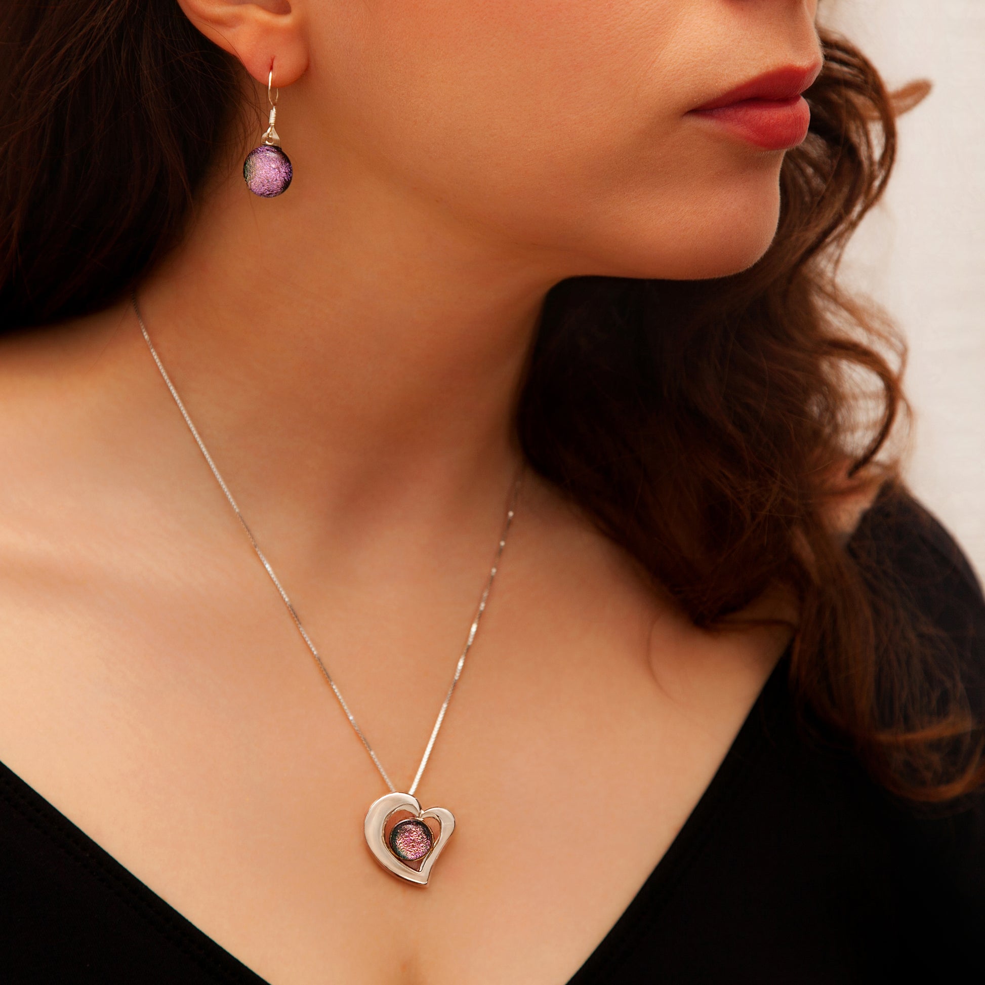 Stella jewellery set featuring pink heart necklace and matching drop earrings with shimmering dichroic glass, handmade in London.