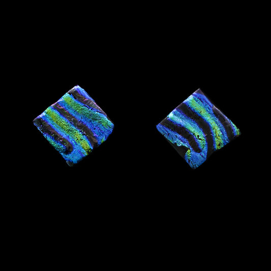 Handmade square stud earrings crafted from dichroic glass with shimmering green and blue ripple patterns, from the Astra Collection by Invoke London.