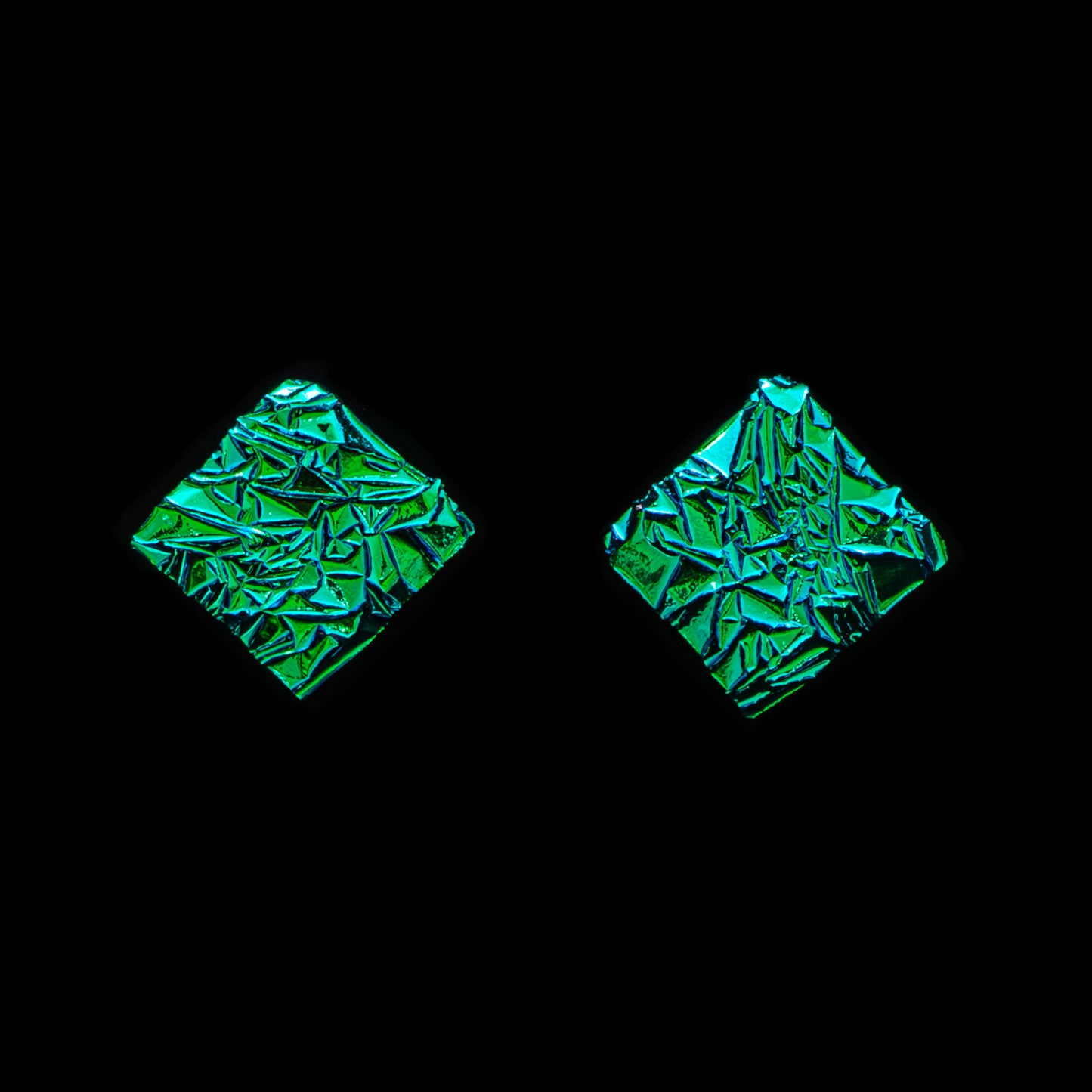Astra collection square stud earrings in green crinkle dichroic glass with shimmering texture, handcrafted by Madiha Zaidi.