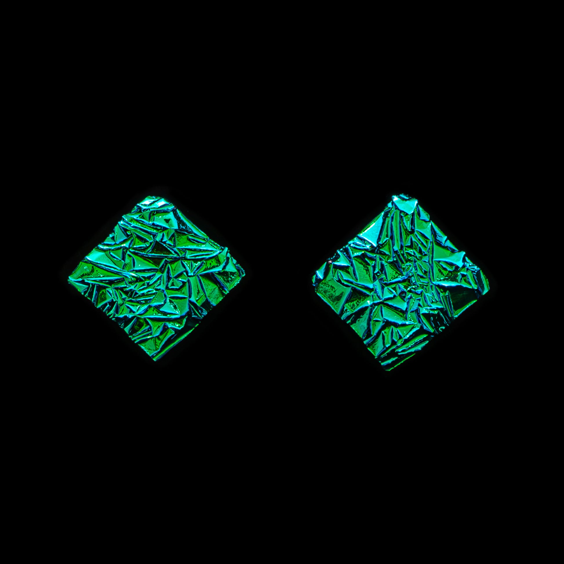 Astra collection square stud earrings in green crinkle dichroic glass with shimmering texture, handcrafted by Madiha Zaidi.