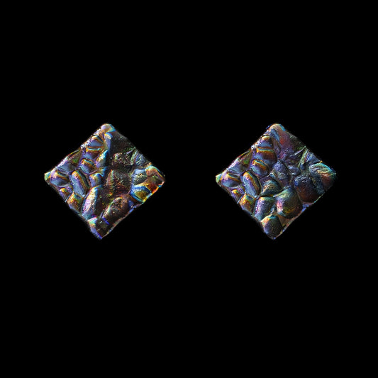 Square stud earrings made from dichroic glass in vibrant peacock colours – artisan jewellery by Invoke London.