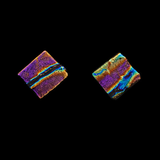Square pink ripple dichroic glass stud earrings with shimmering texture. Handmade by Madiha Zaidi in London. Sterling silver posts.