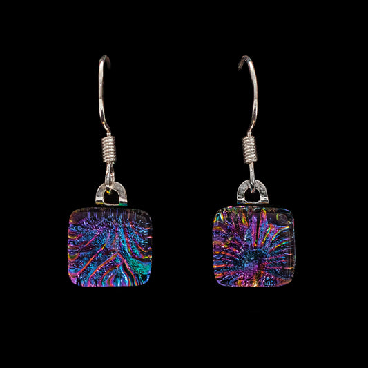 A pair of pink florentine drop earrings with a geometric cube design, featuring dichroic glass and sterling silver hooks.