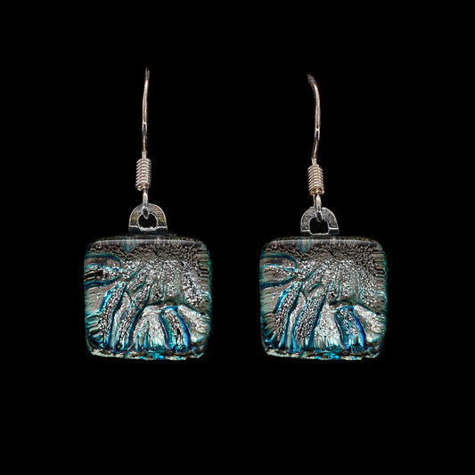 A pair of silver-colored drop earrings with cube-shaped dichroic glass and metal hooks.
