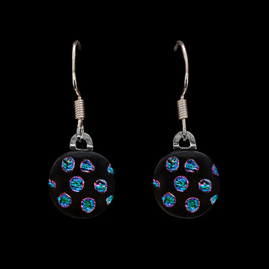 Round drop earrings in the Orb Collection by Invoke London, featuring a black fused glass base with shimmering blue and green dichroic dots and silver-tone hooks.