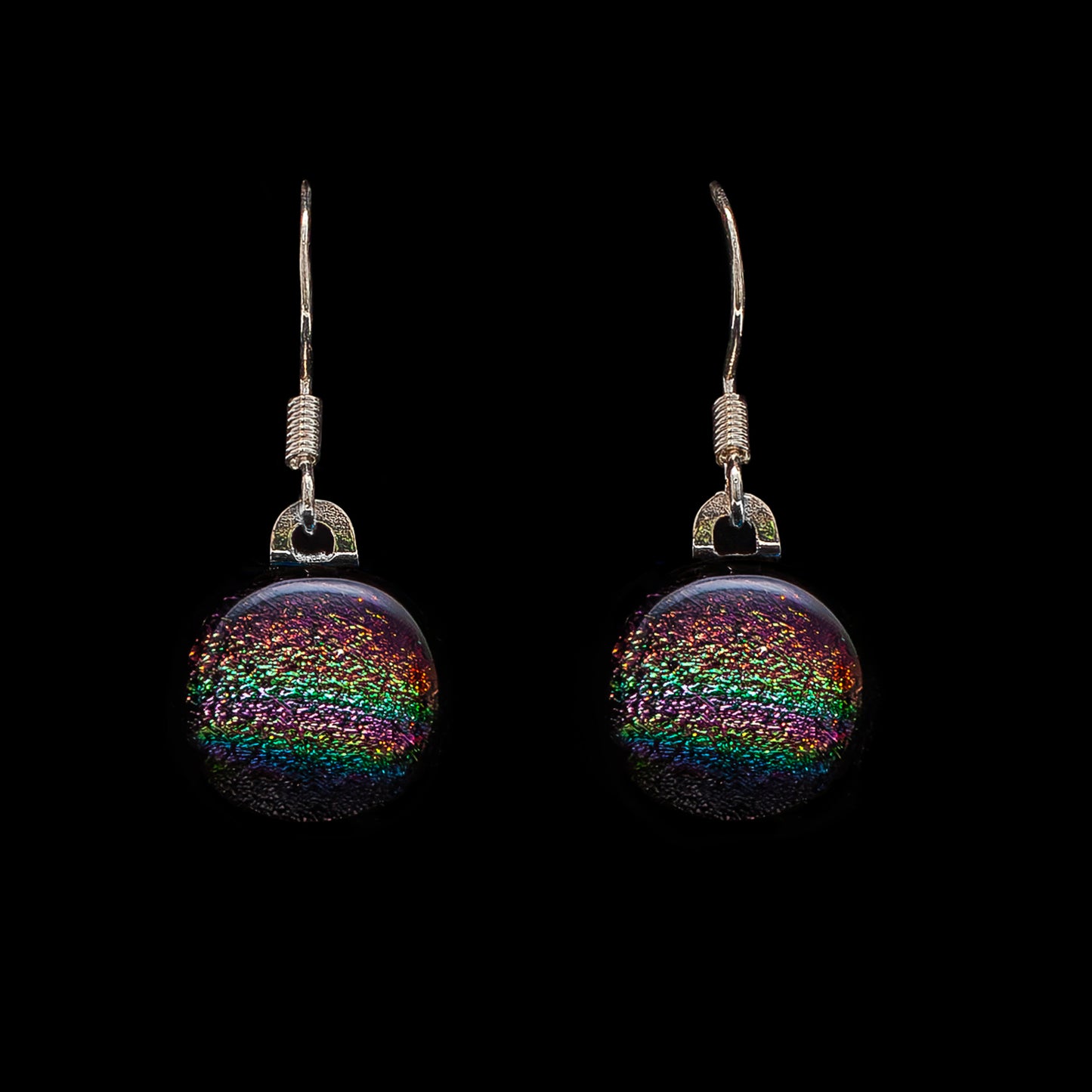 Round pink rainbow dichroic glass drop earrings, handmade in London by Invoke London with sterling silver hooks.