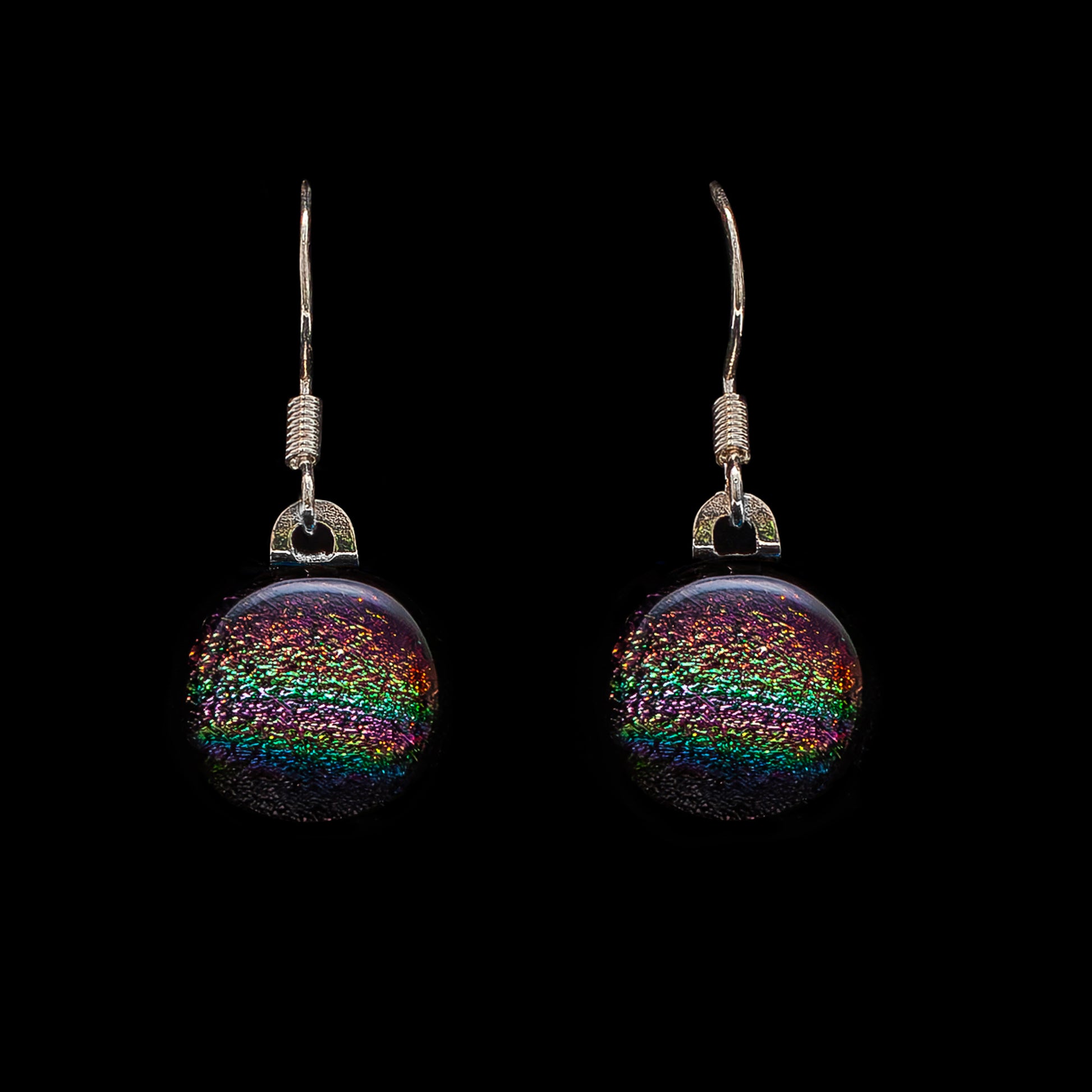 Round pink rainbow dichroic glass drop earrings, handmade in London by Invoke London with sterling silver hooks.