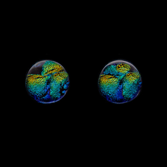 Round green and gold ripple dichroic glass stud earrings with sterling silver backs, handmade in London by glass artist Madiha Zaidi.