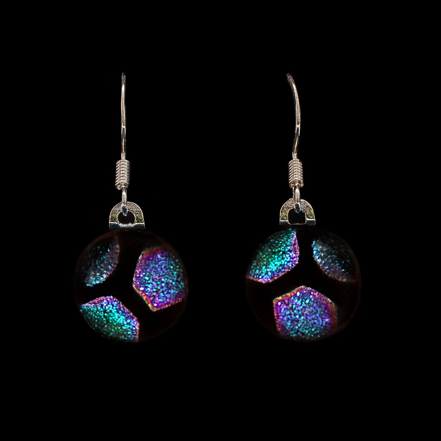 Green hexagon glass drop earrings on a black background