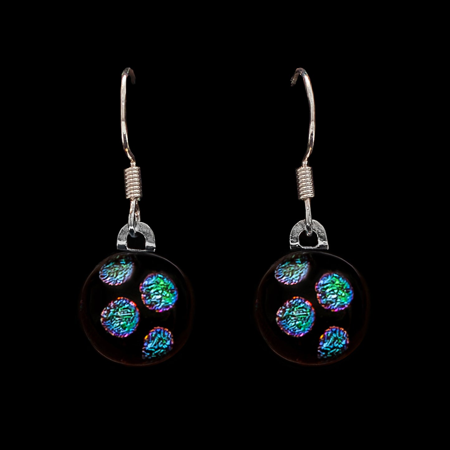 Pair of drop earrings with green dots on a black background