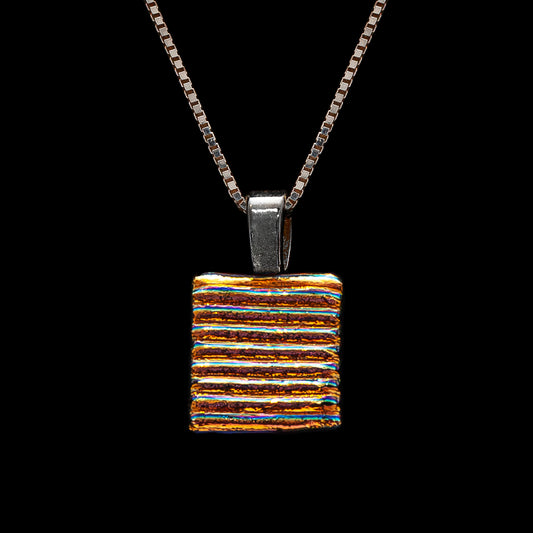 Handmade square pendant necklace featuring golden-silver dichroic glass with bold horizontal stripes, from the Astra Collection by Invoke London.