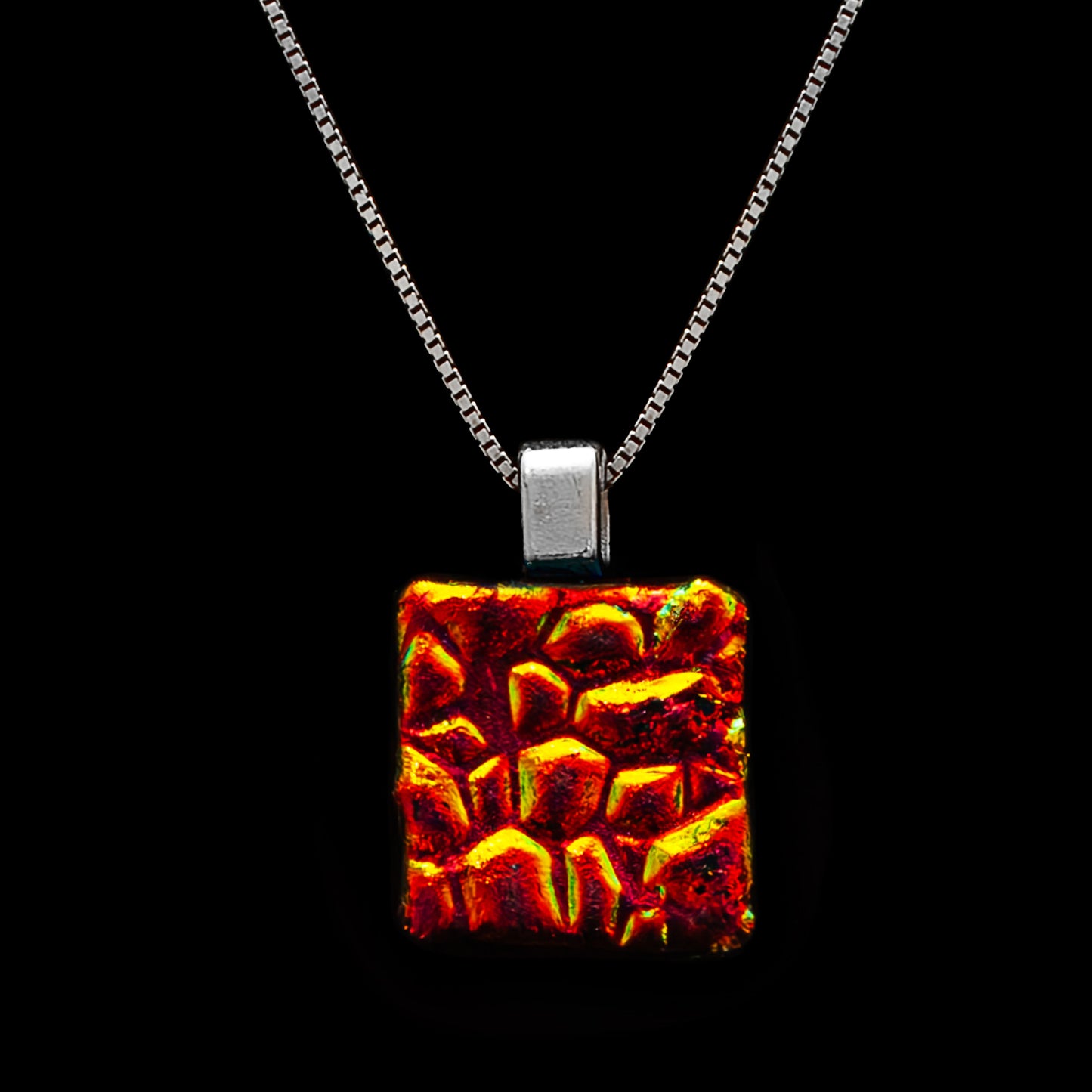 Square dichroic glass pendant in fiery red and gold with dew drop texture. Handcrafted in London, Astra Collection by Invoke London.