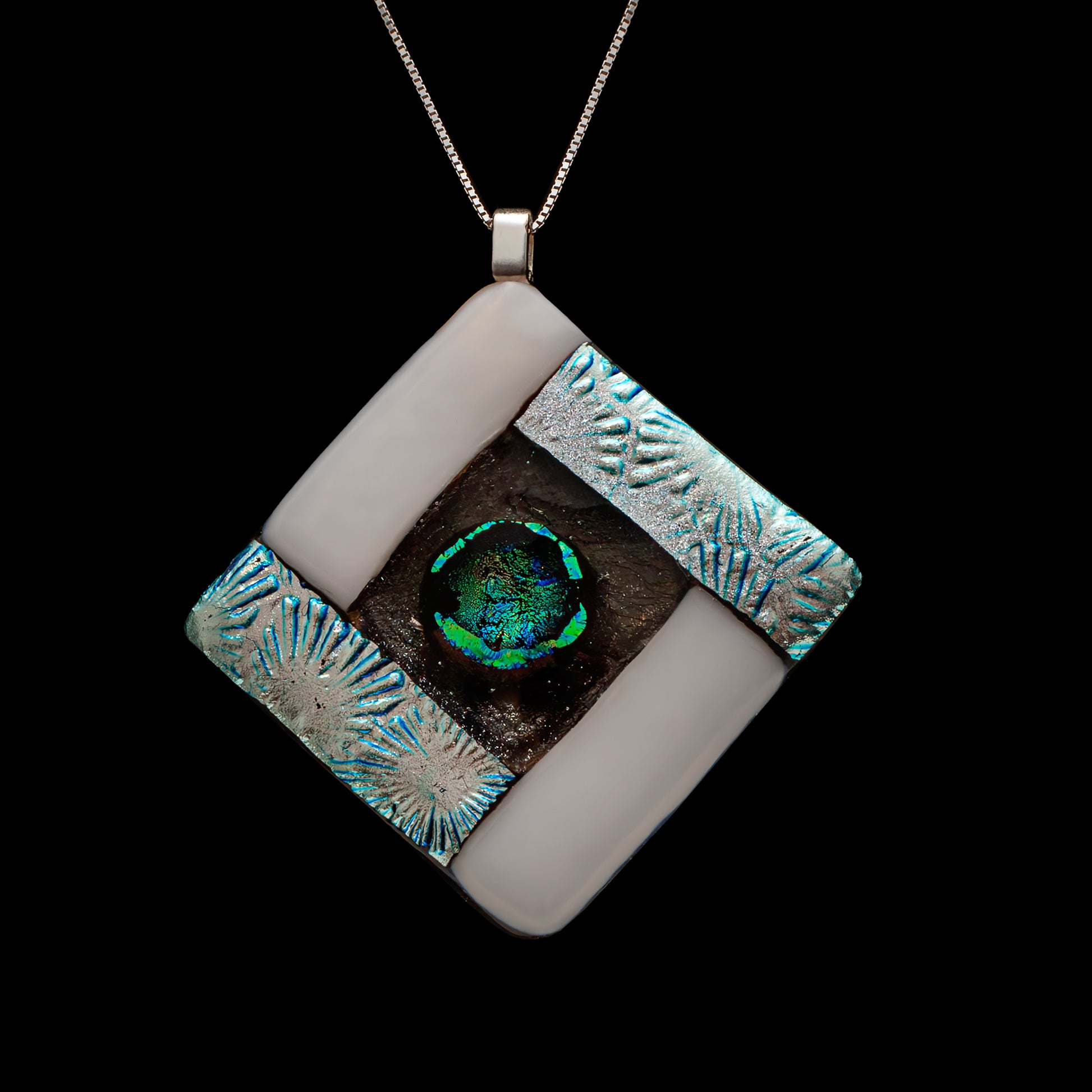 Close-up of a handmade white and silver fused glass necklace with a circular green-blue dichroic glass centre representing the air element, from the Elementa Collection by Invoke London.