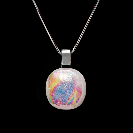 Close-up of Luna June necklace pendant featuring a round pearlescent dichroic glass cabochon with radiant colour-shift glow.