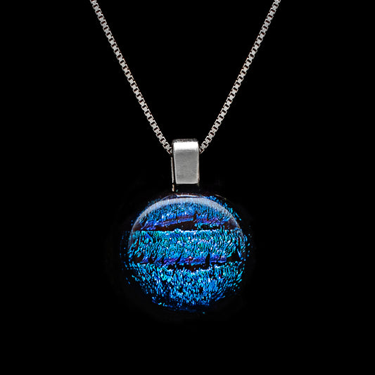 Round blue striped dichroic glass pendant necklace with shimmering texture, handmade in London by Invoke London on a sterling silver chain.