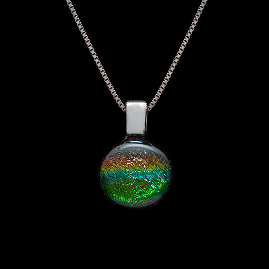 Round green striped dichroic glass pendant with luminous shimmer on sterling silver chain, handmade in London by Invoke London.