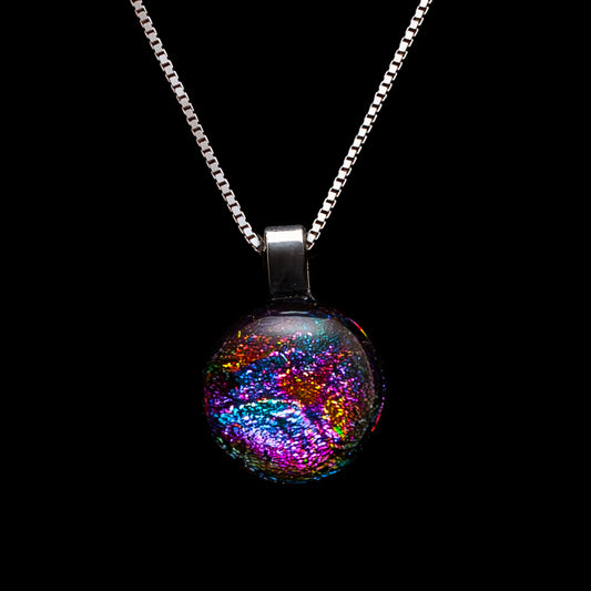 Round pendant necklace with shimmering pink, blue, and gold ripple-effect dichroic glass, handcrafted by Invoke London from the Orb Collection.