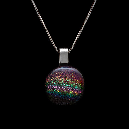 Round pink rainbow dichroic glass pendant on sterling silver chain, handmade in London by Invoke London.