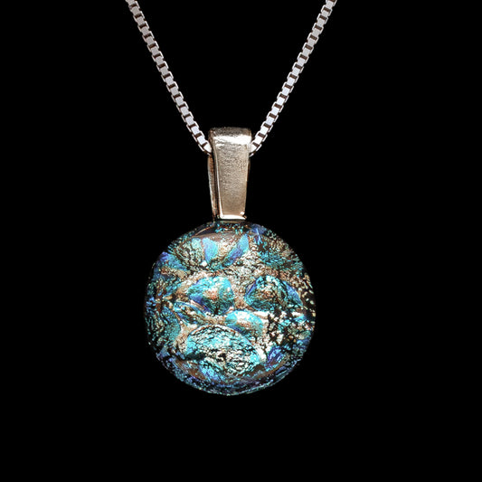 Decorative silver and aqua pendant necklace with intricate design on a black background