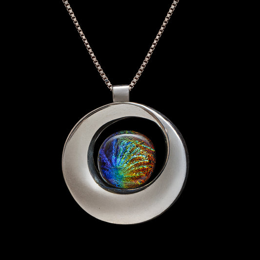 Colourful fused dichroic glass pendant with rainbow tones, handcrafted in a modern silver swirl bail from the Stella Collection by Invoke London.