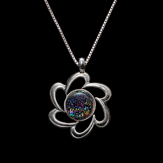 Handmade dichroic glass pendant in a silver flower setting featuring dark multicolour fused glass, from the Stella Collection by Invoke London.