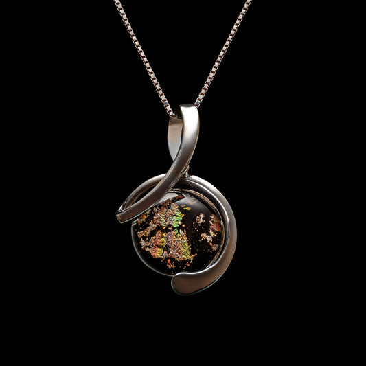 Handmade dichroic glass pendant in a silver twist setting with black fused glass and shimmering gold accents, from the Stella Collection by Invoke London.