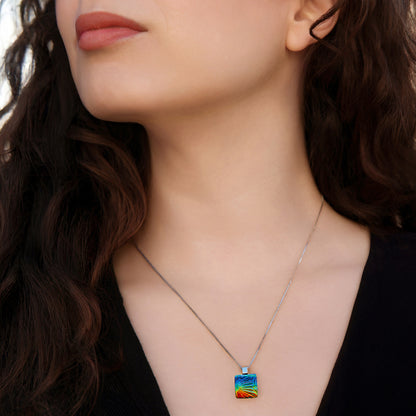 Close-up of woman wearing a rainbow florentine square dichroic glass pendant necklace from the Astra collection by Invoke London.