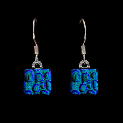 Square blue dew drop dichroic glass drop earrings with textured shimmer, handmade in London by Invoke London with sterling silver hooks.