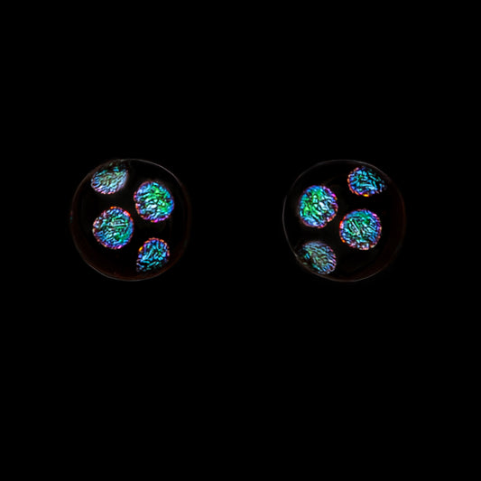 Stud earrings with green dots on a black background
