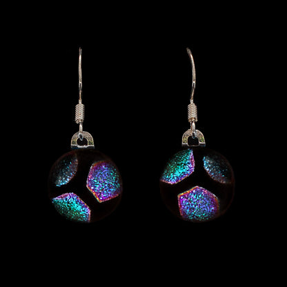 Green hexagon glass drop earrings on a black background