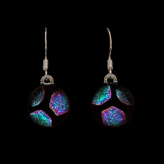 Green hexagon glass drop earrings on a black background