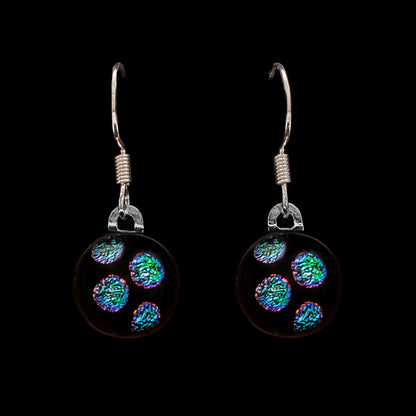 Pair of drop earrings with green dots on a black background