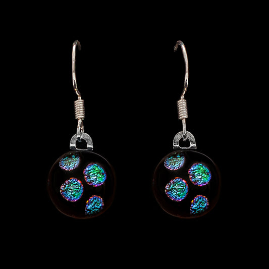 Pair of drop earrings with green dots on a black background