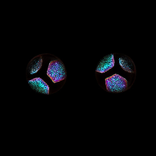 Green hexagon stud earrings on a black background