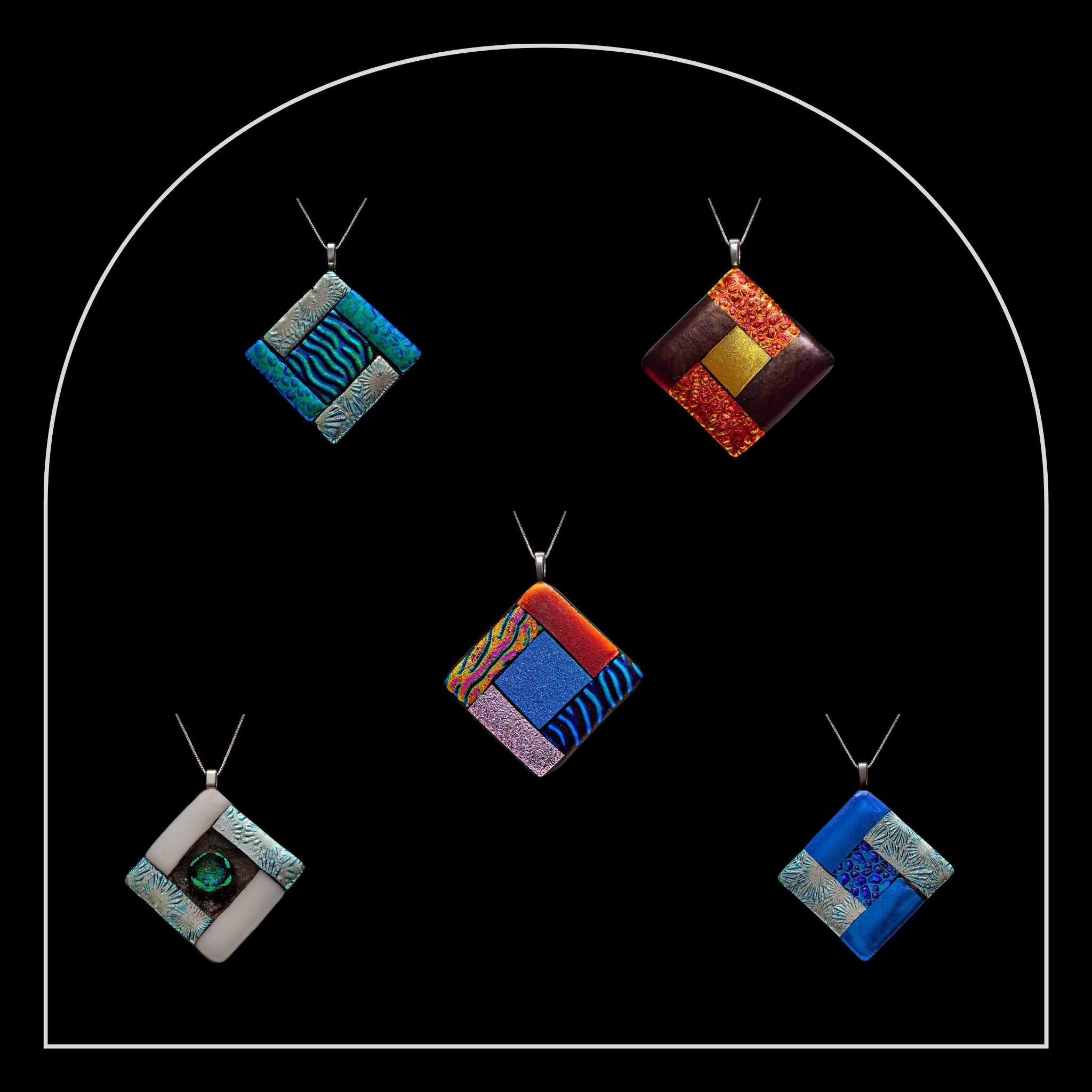 Five square pendants from the Elementa collection by Invoke London, each inspired by Earth, Air, Fire, and Water.