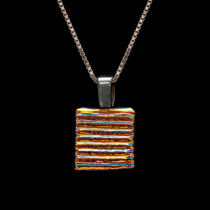 Handmade square pendant necklace featuring golden-silver dichroic glass with bold horizontal stripes, from the Astra Collection by Invoke London.
