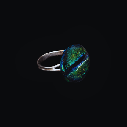 Ring with a colorful gemstone on a black background