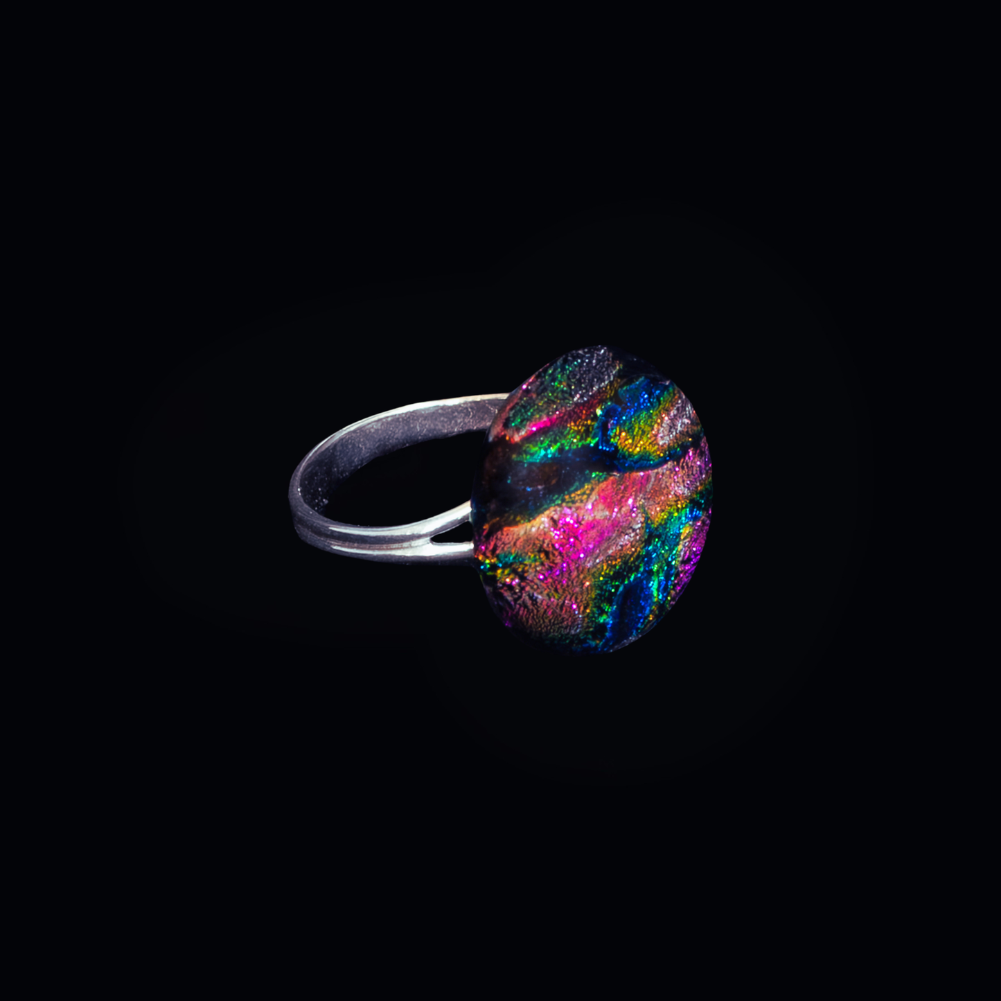 Ring with a colorful gemstone on a black background
